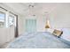 Bedroom with teal closet doors, natural light, ceiling fan, and soft decor at 11225 59Th Ave, Seminole, FL 33772