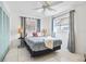 Comfortable bedroom with tile floors, ceiling fan, and ensuite bathroom access at 11225 59Th Ave, Seminole, FL 33772