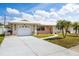 Charming single-story home with a well-manicured lawn, inviting walkway, and attached garage at 11225 59Th Ave, Seminole, FL 33772