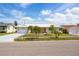 Charming single-story home featuring an attached garage, well-manicured front lawn, and tropical landscaping at 11225 59Th Ave, Seminole, FL 33772