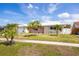 Charming single-story home with a well-manicured lawn and mature palm trees enhancing the curb appeal at 11225 59Th Ave, Seminole, FL 33772