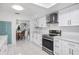 Well-lit kitchen featuring modern appliances, sleek cabinetry, and open access to the dining area at 11225 59Th Ave, Seminole, FL 33772