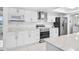 Modern kitchen with white cabinets, stainless steel appliances, and bright natural light at 11225 59Th Ave, Seminole, FL 33772