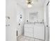 Bright laundry room featuring a washer, dryer, ceiling fan, and white cabinets for storage at 11225 59Th Ave, Seminole, FL 33772