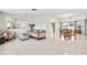 Bright and open living area with tile flooring, a large mirror, and neutral-toned furniture at 11225 59Th Ave, Seminole, FL 33772