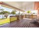 A shot of the covered patio with wood flooring and privacy railing for backyard entertaining at 11225 59Th Ave, Seminole, FL 33772