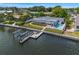 Aerial view of waterfront home featuring a private boat dock, lush landscaping, and easy water access at 1124 35Th Ne Ave, St Petersburg, FL 33704