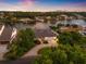 Breathtaking aerial view of a waterfront home with lush landscaping and stunning sunset sky at 1124 35Th Ne Ave, St Petersburg, FL 33704
