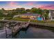 Aerial view showcasing a waterfront property with a pool, dock, and manicured backyard at 1124 35Th Ne Ave, St Petersburg, FL 33704
