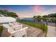 Inviting back patio with white Adirondack chairs and peaceful water views from the fenced-in backyard at 1124 35Th Ne Ave, St Petersburg, FL 33704
