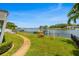 Beautiful waterfront backyard with mature trees, space for outdoor play, and a private dock at 1124 35Th Ne Ave, St Petersburg, FL 33704