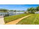 Spacious backyard featuring well-maintained lawn space, a dock for boating, and a playful play area at 1124 35Th Ne Ave, St Petersburg, FL 33704
