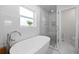 Modern bathroom featuring a soaking tub and glass-enclosed shower at 1124 35Th Ne Ave, St Petersburg, FL 33704