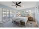This light and airy bedroom features tile flooring, white shutters, and a modern ceiling fan at 1124 35Th Ne Ave, St Petersburg, FL 33704