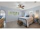 Bright bedroom featuring a fan, shutters, and wooden floors at 1124 35Th Ne Ave, St Petersburg, FL 33704