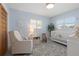 Lovely Bedroom with a cozy rocking chair, white crib, and charming floral rug at 1124 35Th Ne Ave, St Petersburg, FL 33704