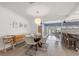 Bright dining area featuring a modern glass table, stylish furnishings, and a view into the living room at 1124 35Th Ne Ave, St Petersburg, FL 33704