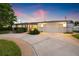 Charming home featuring a circular driveway, well-maintained landscaping, and a two-car garage at 1124 35Th Ne Ave, St Petersburg, FL 33704