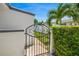 Ornate iron gate and lush greenery adds charm and privacy to this lovely home at 1124 35Th Ne Ave, St Petersburg, FL 33704