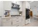 Well-equipped kitchen featuring white cabinets, granite countertops, gas range, and stainless steel appliances at 1124 35Th Ne Ave, St Petersburg, FL 33704