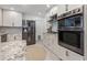 Well-lit kitchen featuring stainless steel appliances, granite countertops, and white cabinetry at 1124 35Th Ne Ave, St Petersburg, FL 33704