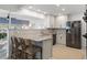 Modern kitchen with granite countertops, stainless steel appliances, and a cozy breakfast bar at 1124 35Th Ne Ave, St Petersburg, FL 33704