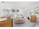 Cozy living area featuring a white sofa, round coffee table, and stylish decor at 1124 35Th Ne Ave, St Petersburg, FL 33704