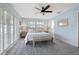 Bright main bedroom with shutters, ceiling fan, and en suite bathroom at 1124 35Th Ne Ave, St Petersburg, FL 33704
