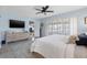 Bright main bedroom with shutters, TV, and view of the intercostal waterway at 1124 35Th Ne Ave, St Petersburg, FL 33704
