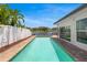 Inviting private pool with waterfront view, enhanced by beautiful landscaping and a white privacy fence at 1124 35Th Ne Ave, St Petersburg, FL 33704