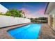 Sparkling in-ground pool surrounded by brick pavers and a white privacy fence for relaxed outdoor living at 1124 35Th Ne Ave, St Petersburg, FL 33704