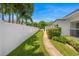 Landscaped side yard with green grass and white privacy fence offers a serene and well-maintained outdoor space at 1124 35Th Ne Ave, St Petersburg, FL 33704