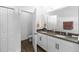 Elegant bathroom boasts double sinks, granite countertops, and wood-look flooring for a stylish design at 11819 Brighton Knoll Loop, Riverview, FL 33579