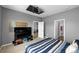 Cozy bedroom featuring neutral walls, carpet, and entertainment center with mounted television at 11819 Brighton Knoll Loop, Riverview, FL 33579