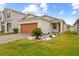 Single-story home with a well-manicured lawn and a brick-paved driveway at 11819 Brighton Knoll Loop, Riverview, FL 33579