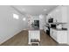 Stylish kitchen with white cabinets, island seating, and stainless steel appliances, perfect for cooking at 11819 Brighton Knoll Loop, Riverview, FL 33579