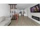 Open-concept living space with wood-look tile, dining area, and living room including electric fireplace at 11819 Brighton Knoll Loop, Riverview, FL 33579