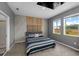 Modern bedroom with a large bed, stylish headboard, and bright windows at 11819 Brighton Knoll Loop, Riverview, FL 33579