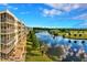 View of the lake, golf course and condo buildings with screened porches at 1200 Country Club Dr # 5506, Largo, FL 33771