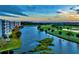 Gorgeous sunset aerial view of the lake and golf course surrounded by upscale condo buildings at 1200 Country Club Dr # 5506, Largo, FL 33771