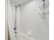 Clean white bathroom featuring a tiled shower and chrome shower head at 1200 Country Club Dr # 5506, Largo, FL 33771