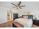 Comfortable main bedroom with ceiling fan, plush rug and artwork at 1200 Country Club Dr # 5506, Largo, FL 33771
