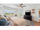 Comfortable main bedroom with ceiling fan, balcony access, and television console at 1200 Country Club Dr # 5506, Largo, FL 33771
