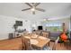 Inviting dining area featuring hardwood floors and a charming wooden dining set, adjacent to a comfortable living space at 1200 Country Club Dr # 5506, Largo, FL 33771