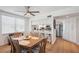 Sunlit dining area with wood floors, stylish dining set, and a breakfast bar overlooking a modern kitchen at 1200 Country Club Dr # 5506, Largo, FL 33771