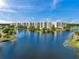 Beautifully landscaped condo buildings along the lakefront with lush trees and manicured lawns at 1200 Country Club Dr # 5506, Largo, FL 33771