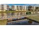 Scenic view of the pedestrian bridge with reflections over the lake and condo buildings at 1200 Country Club Dr # 5506, Largo, FL 33771
