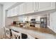 Modern kitchen with stainless steel appliances, granite countertops, and a breakfast bar for casual dining at 1200 Country Club Dr # 5506, Largo, FL 33771