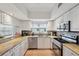 Well-equipped kitchen boasts granite counters, stainless appliances, and ample storage in bright, white cabinetry at 1200 Country Club Dr # 5506, Largo, FL 33771