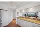 Bright kitchen featuring granite counters, white cabinetry and stainless appliances at 1200 Country Club Dr # 5506, Largo, FL 33771